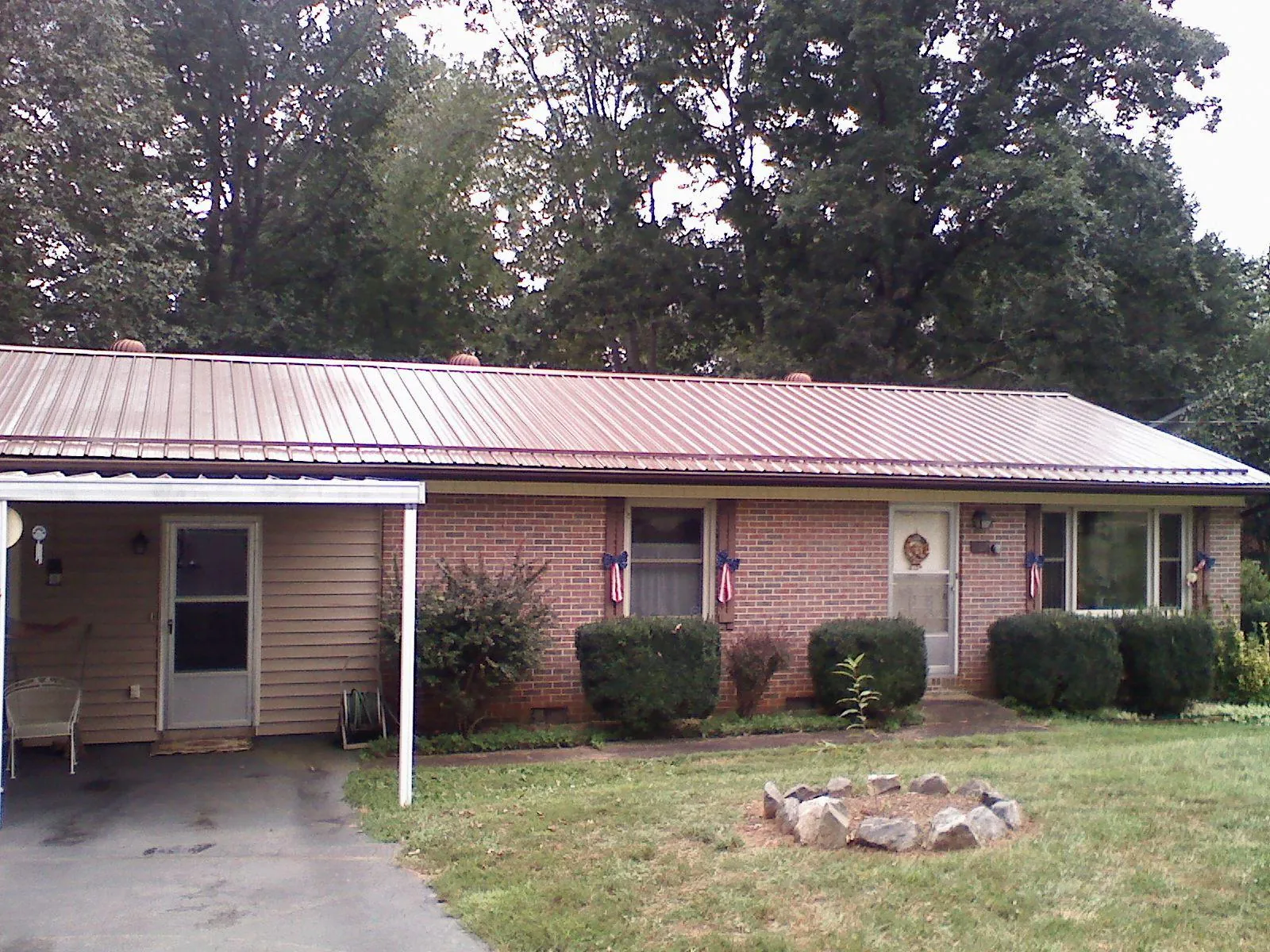Bronze metal roof and carport on a brick ranch home — Roof Repair work by our crew in Morven
