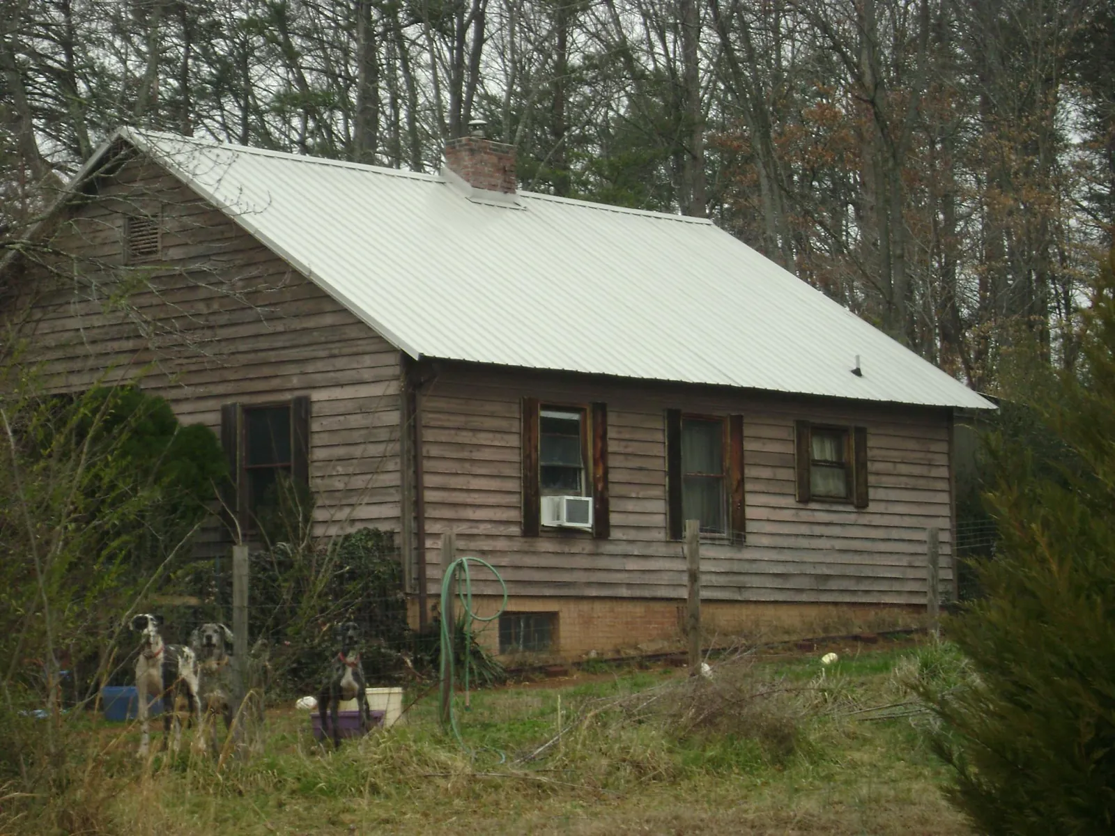 White metal roof on an old wood sided farmhouse, from a Metal Roof Installation job in Morven